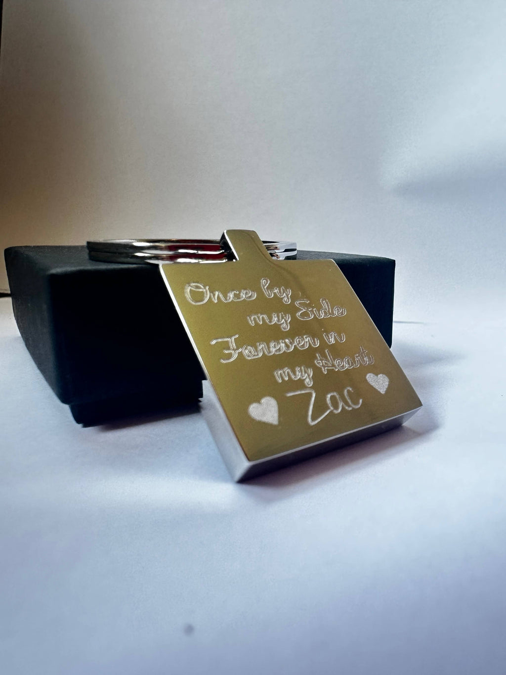 Stainless Steel square keychain with engraved text reading Once by my side forever in my heart.