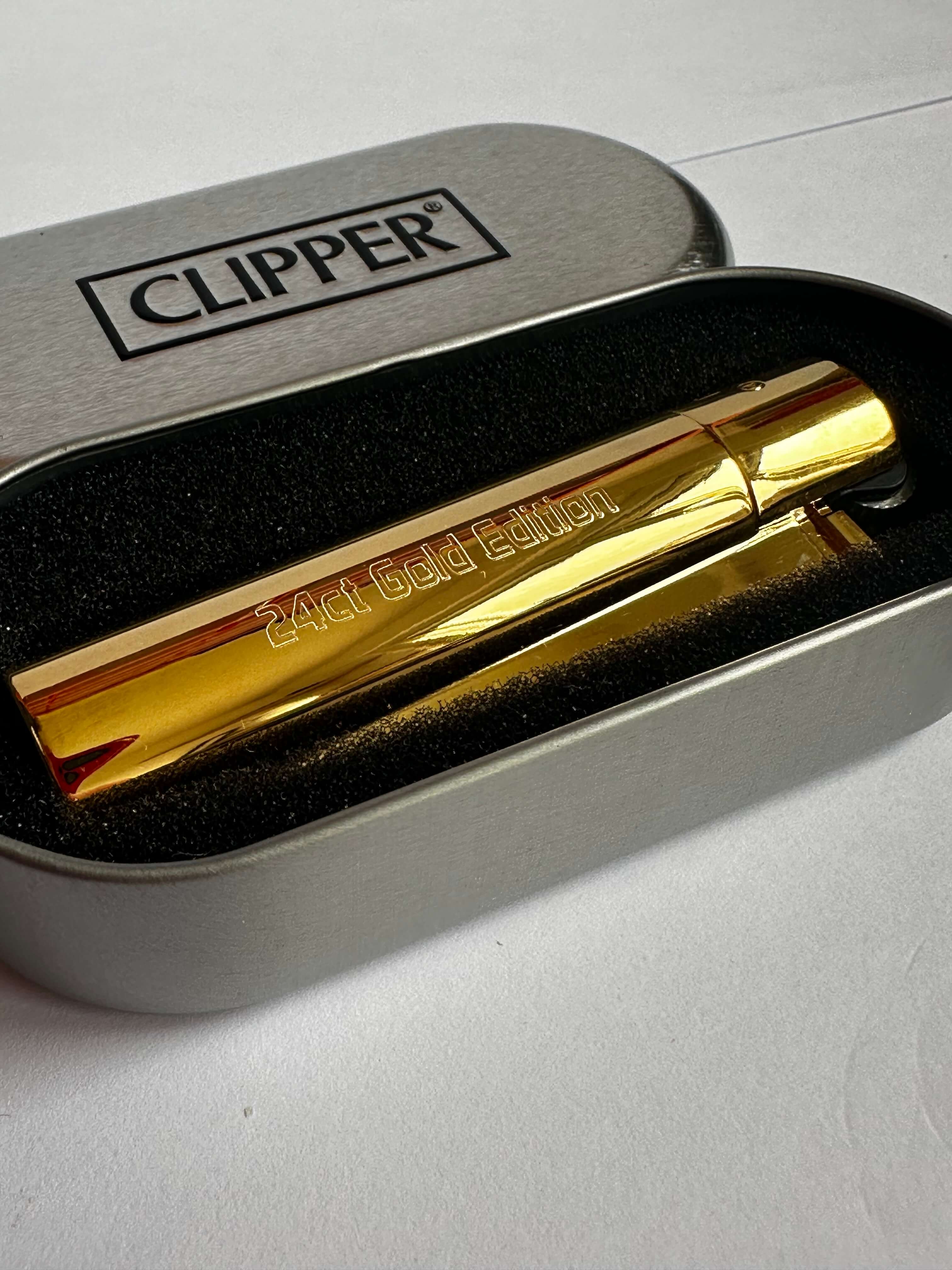 Gold lighter with '24ct Gold Edition' text in a Clipper branded case.